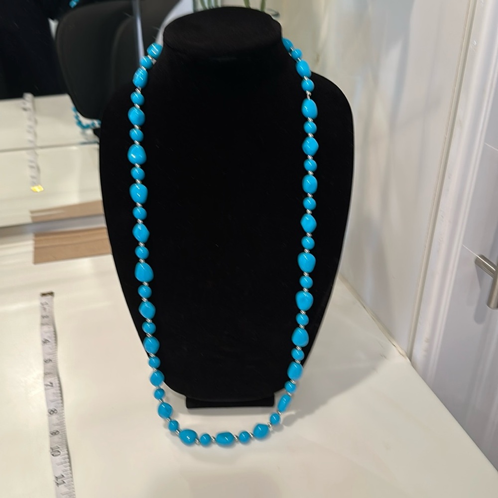 Turquoise and silver necklace.